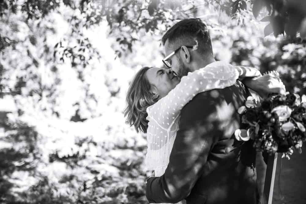 beautiful black white photo bride groom happy couple posing smiling wedding dress